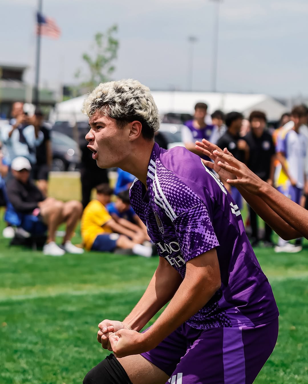 Player in purple celebrating a goal