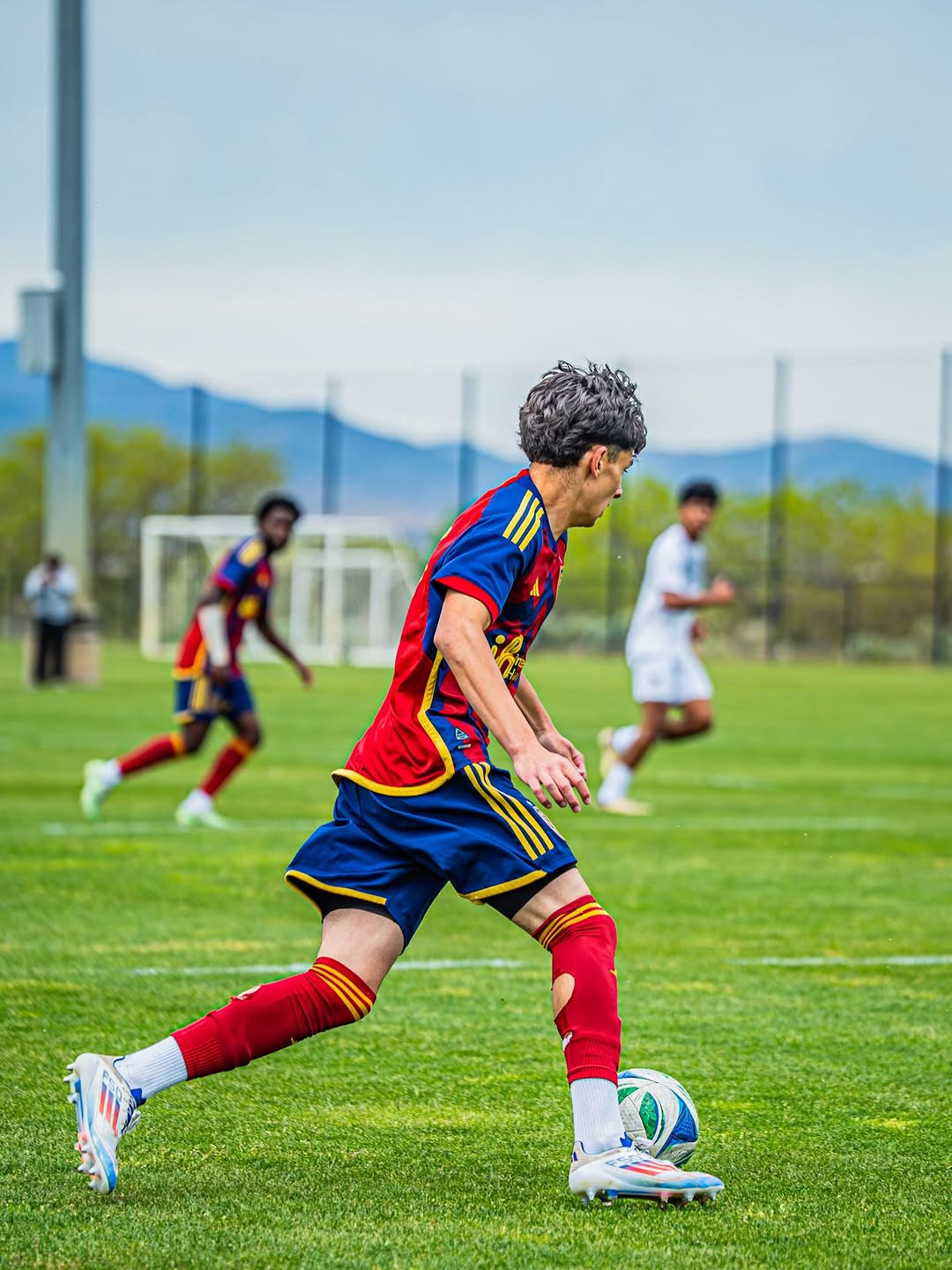 Winger in red and blue attacking down the flank