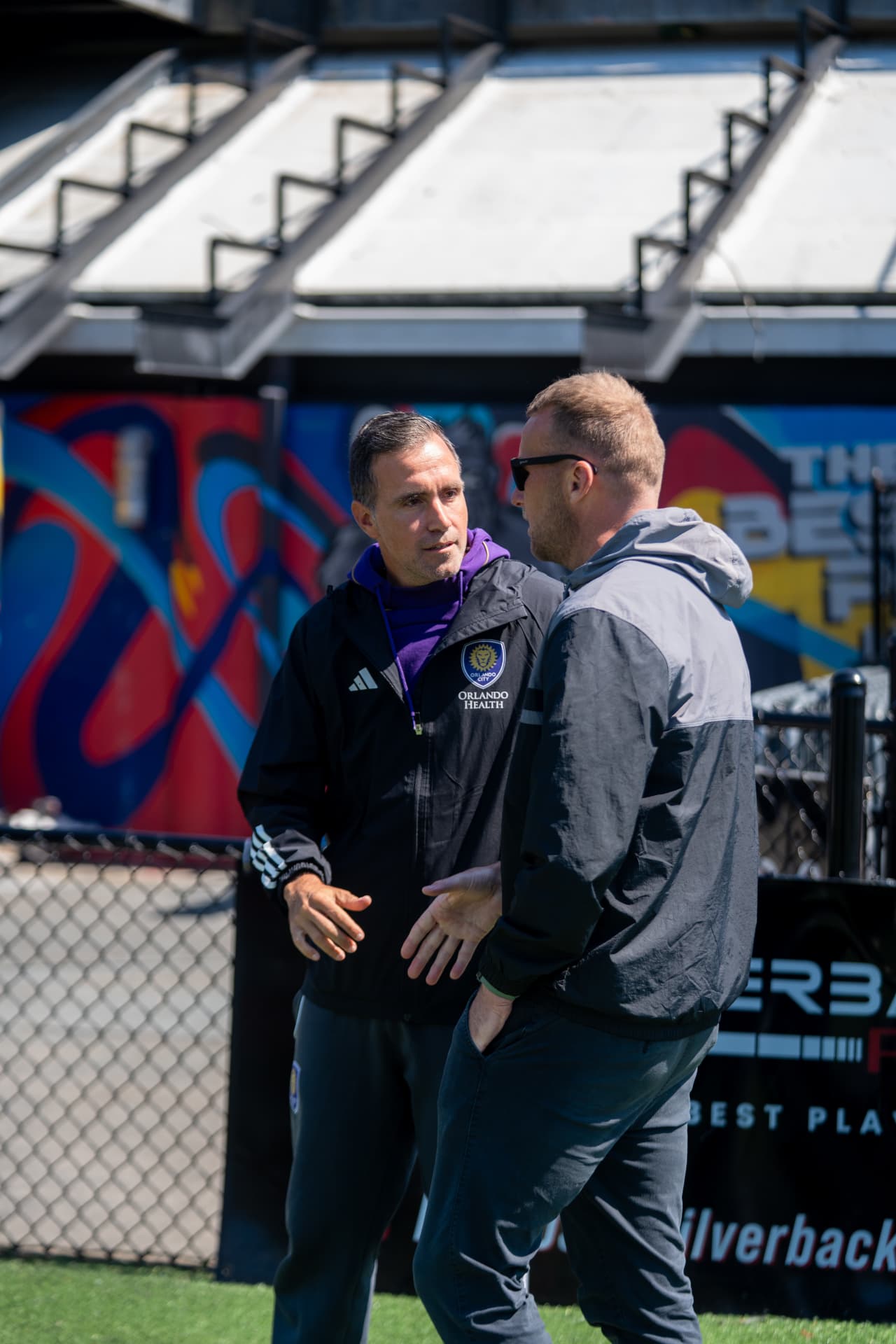 MLS academy staff talking pitchside at an OPSM event