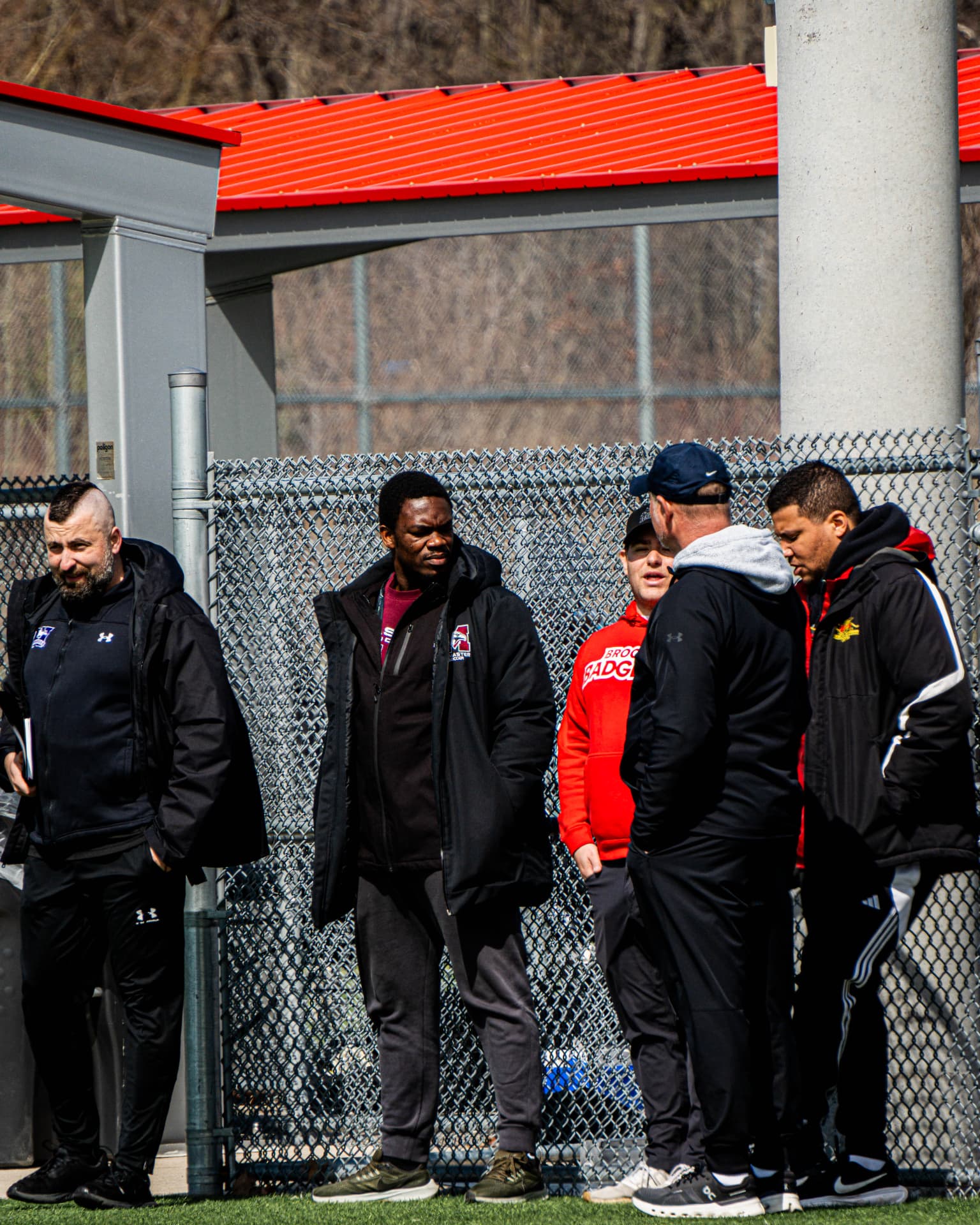 College and academy coaches watching from the touchline